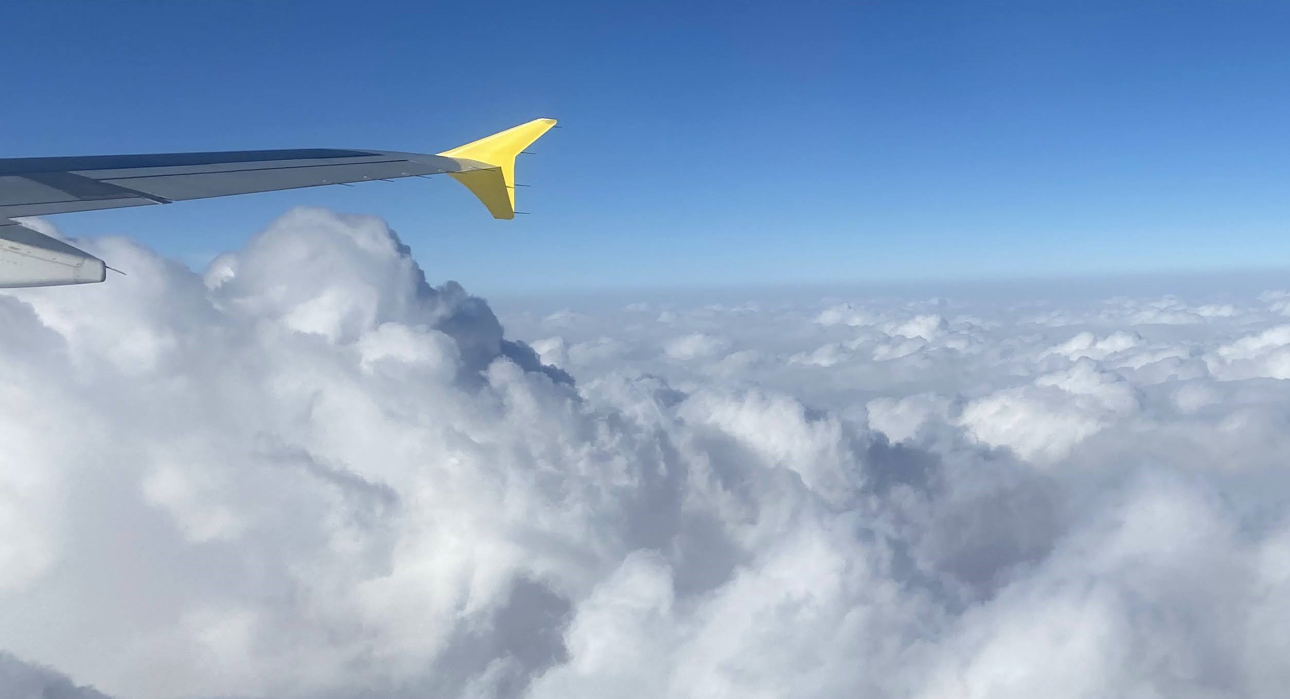 Plane wing above clouds